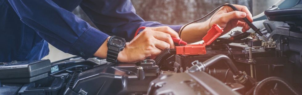 mechanic pouring engine oil under a vehicle hood